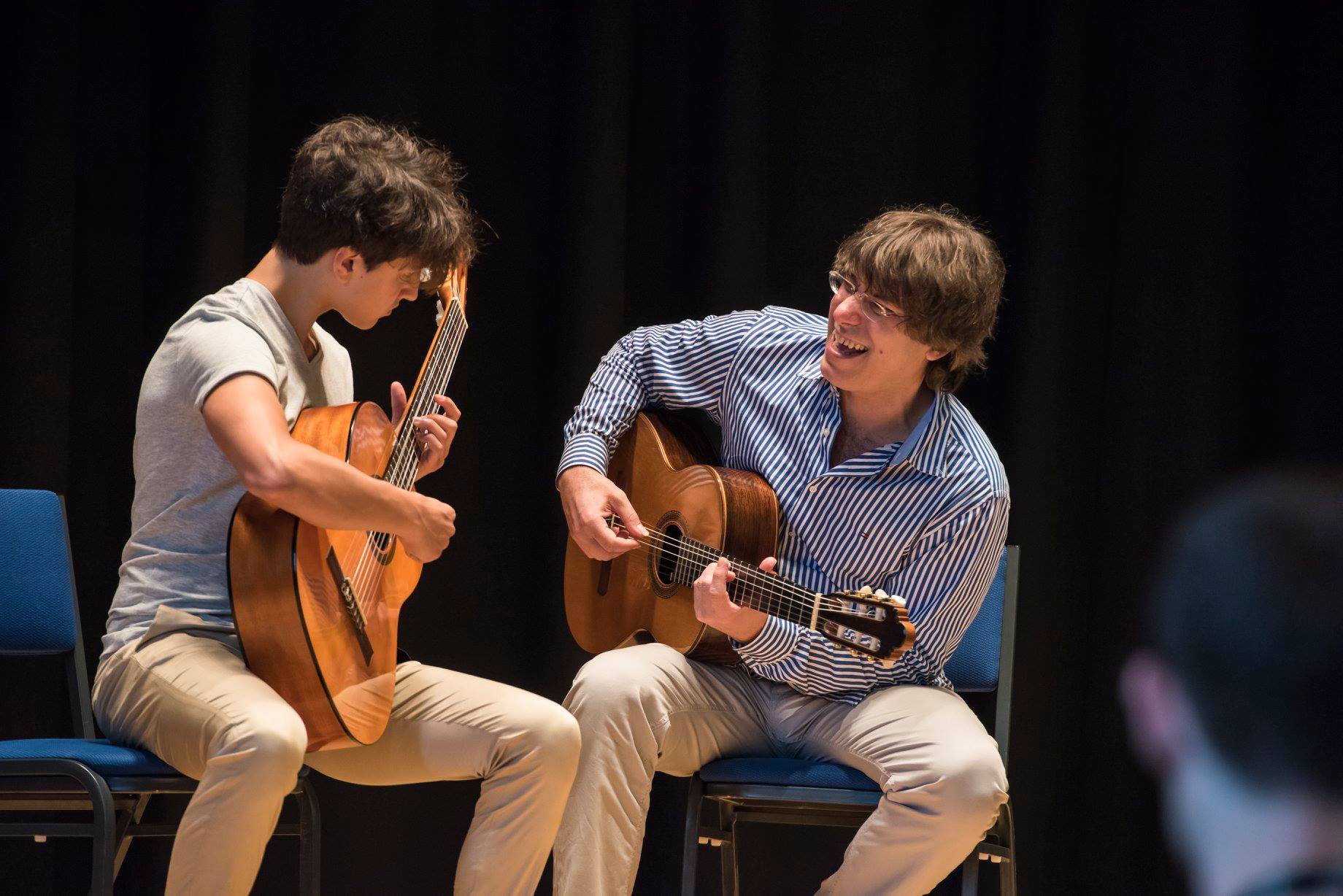 student and teacher on stage at guitarfest