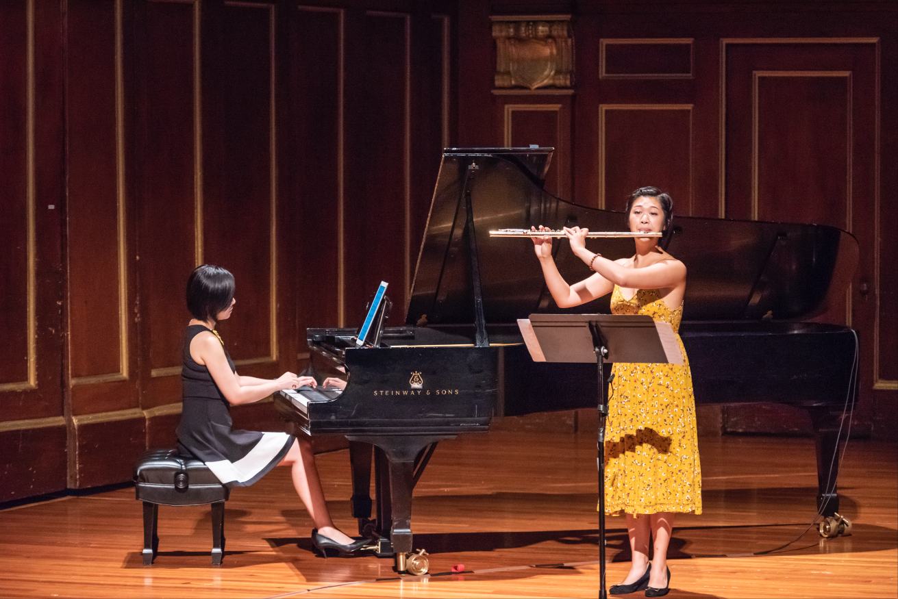 Feng Niu playing piano and Annie Wu playing flute