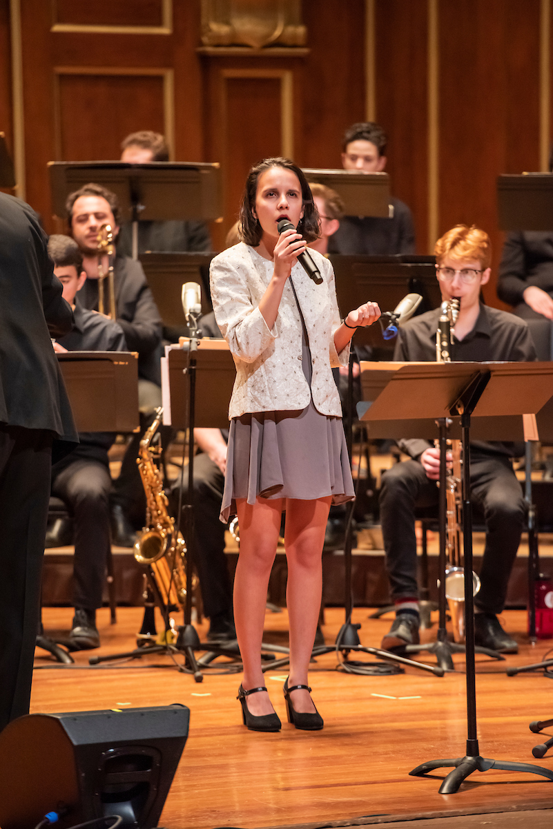 Priya Carlberg sings as a soloist with the NEC Jazz Orchestra behind her.
