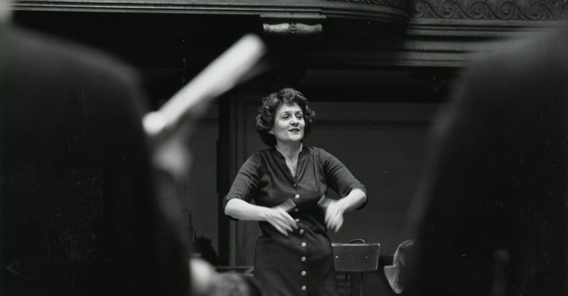Lorna Cooke deVaron conducts, in a photo taken from the perspective of the chorus.