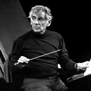 Leonard Bernstein conducting, holding a baton in his right hand.