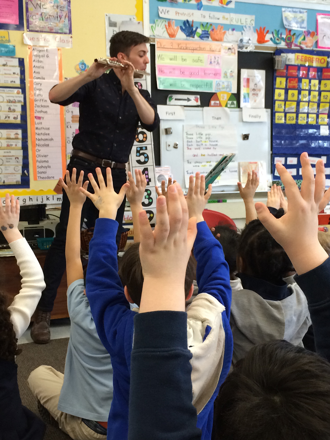  A flutist plays for a classroom full of eager listeners