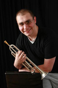 Josh Gilbert holding a trumpet