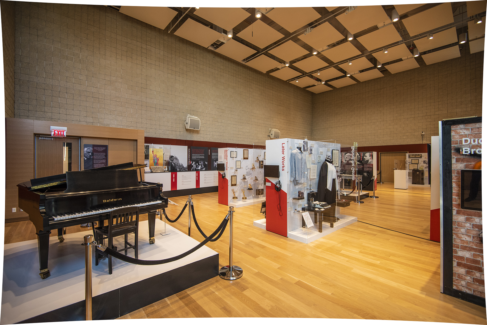Leonard Bernstein at 100 exhibit installed at NEC's Burnes Hall. A piano is visible on the left with other items on display in the rest of the hall.