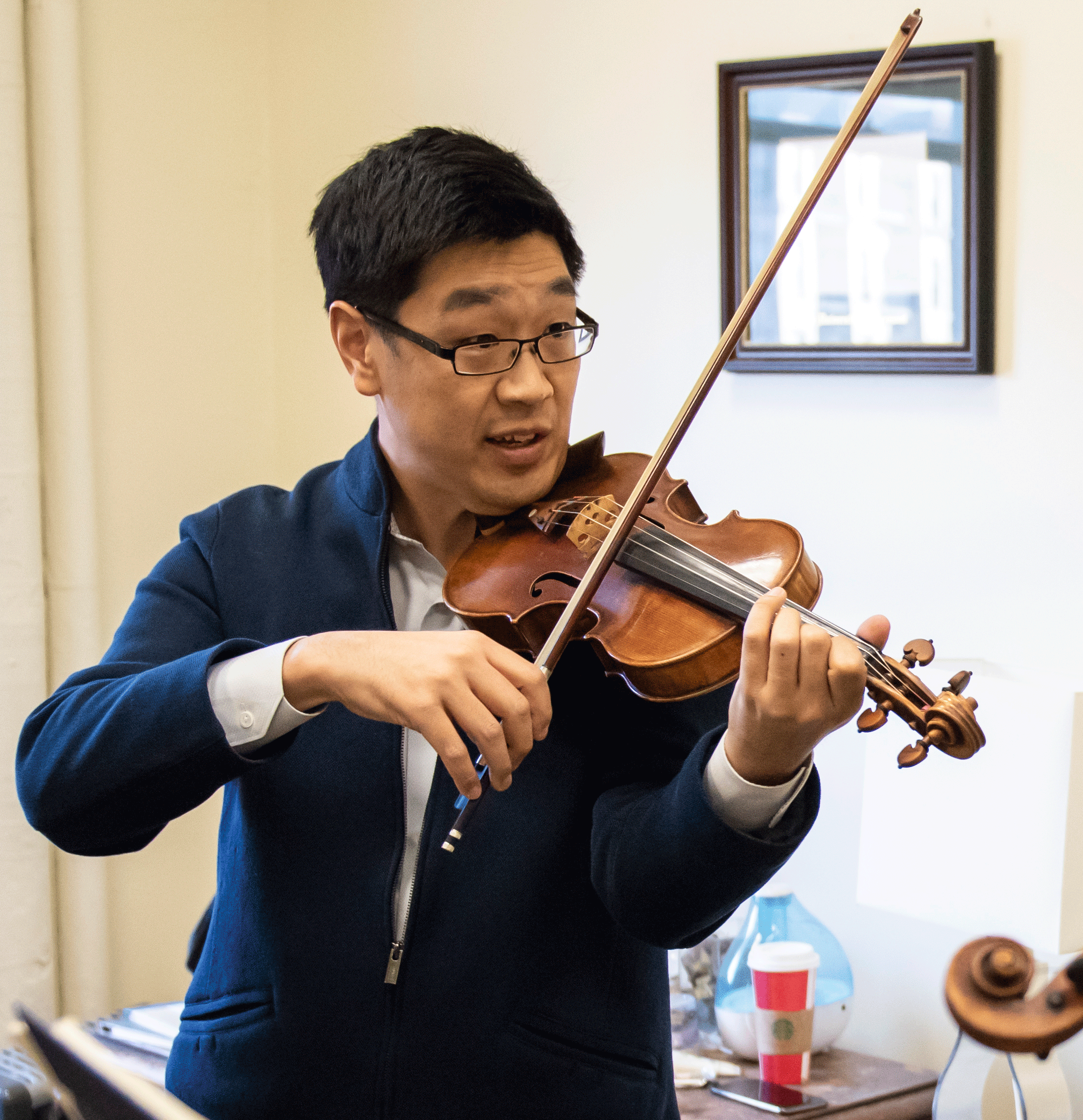 Soovin Kim plays the violin while teaching a student