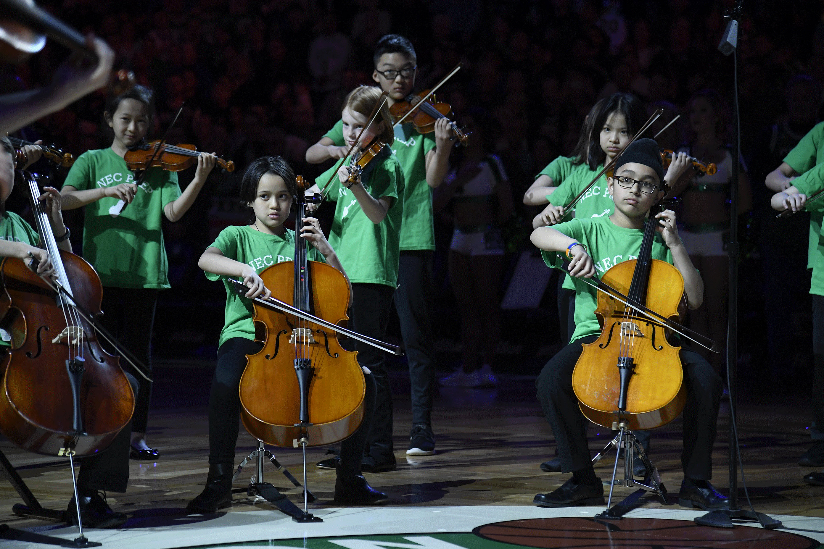 Children in NEC's Suzuki Prep program play at the Celtics stadium