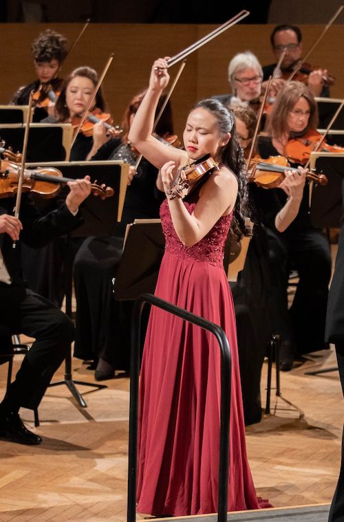Stella Chen closes her eyes and lifts her bow from her violin