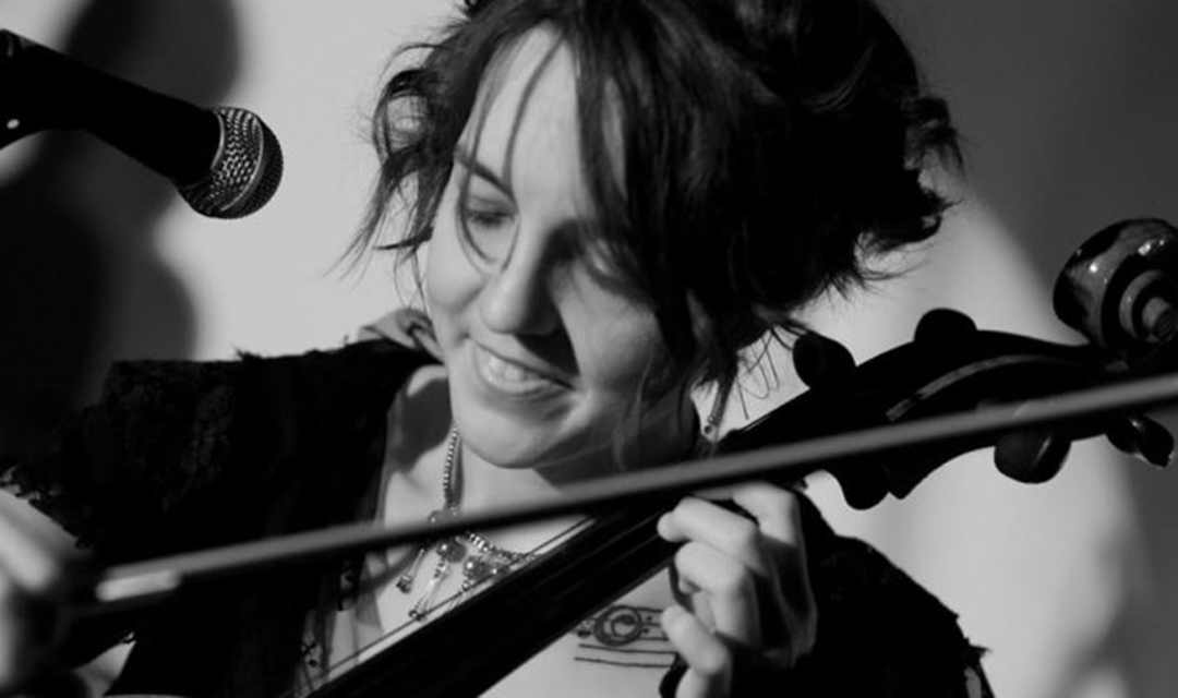 Black and white photo of Valerie Thompson playing the cello
