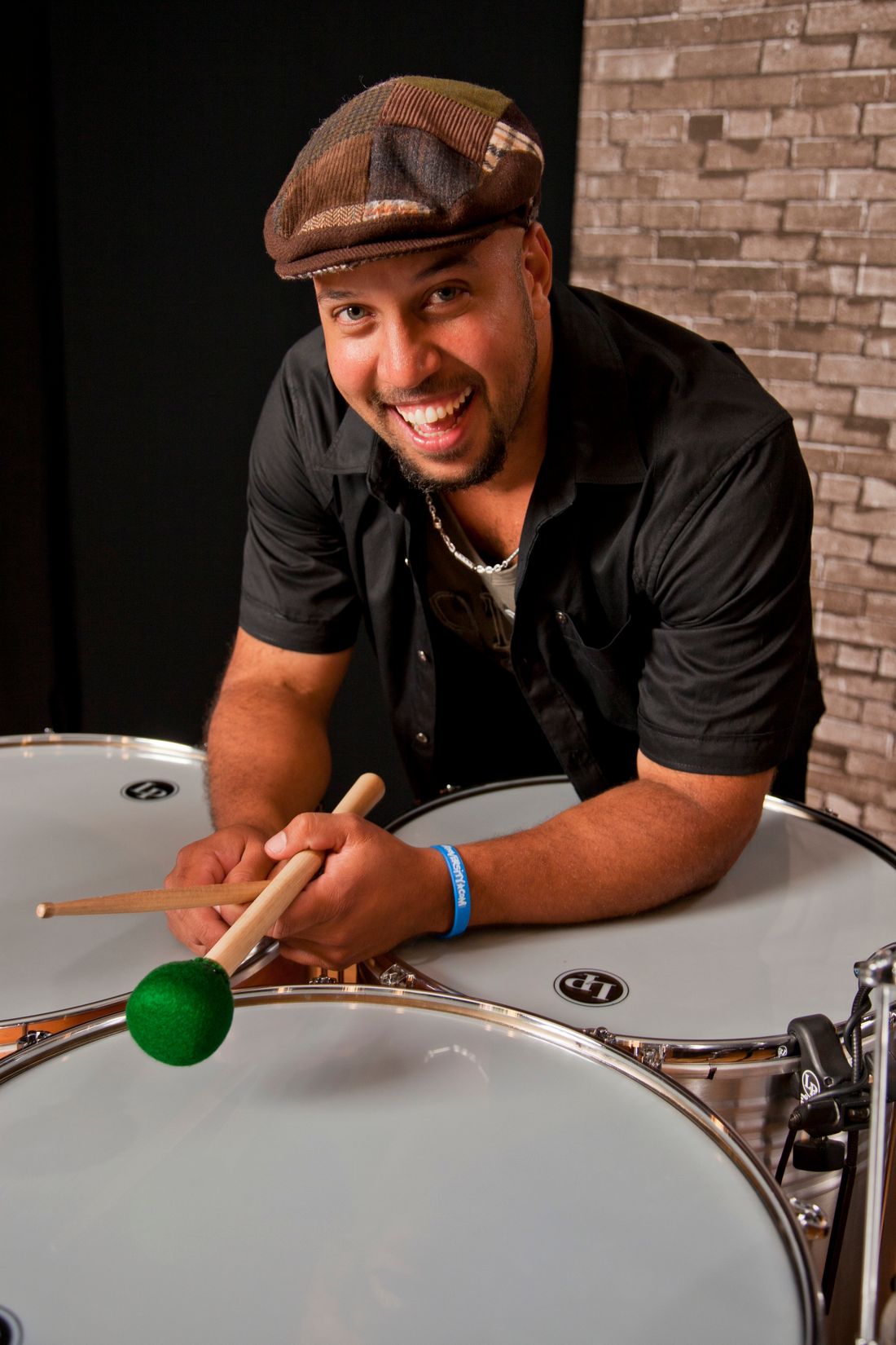 Marcus Santos headshot with drums