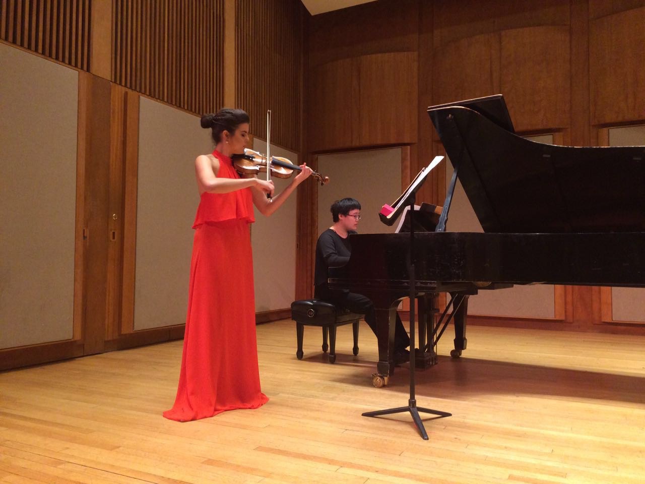 Julia Bomfim plays violin in Pickman Hall at Longy School of Music, with a collaborative pianist