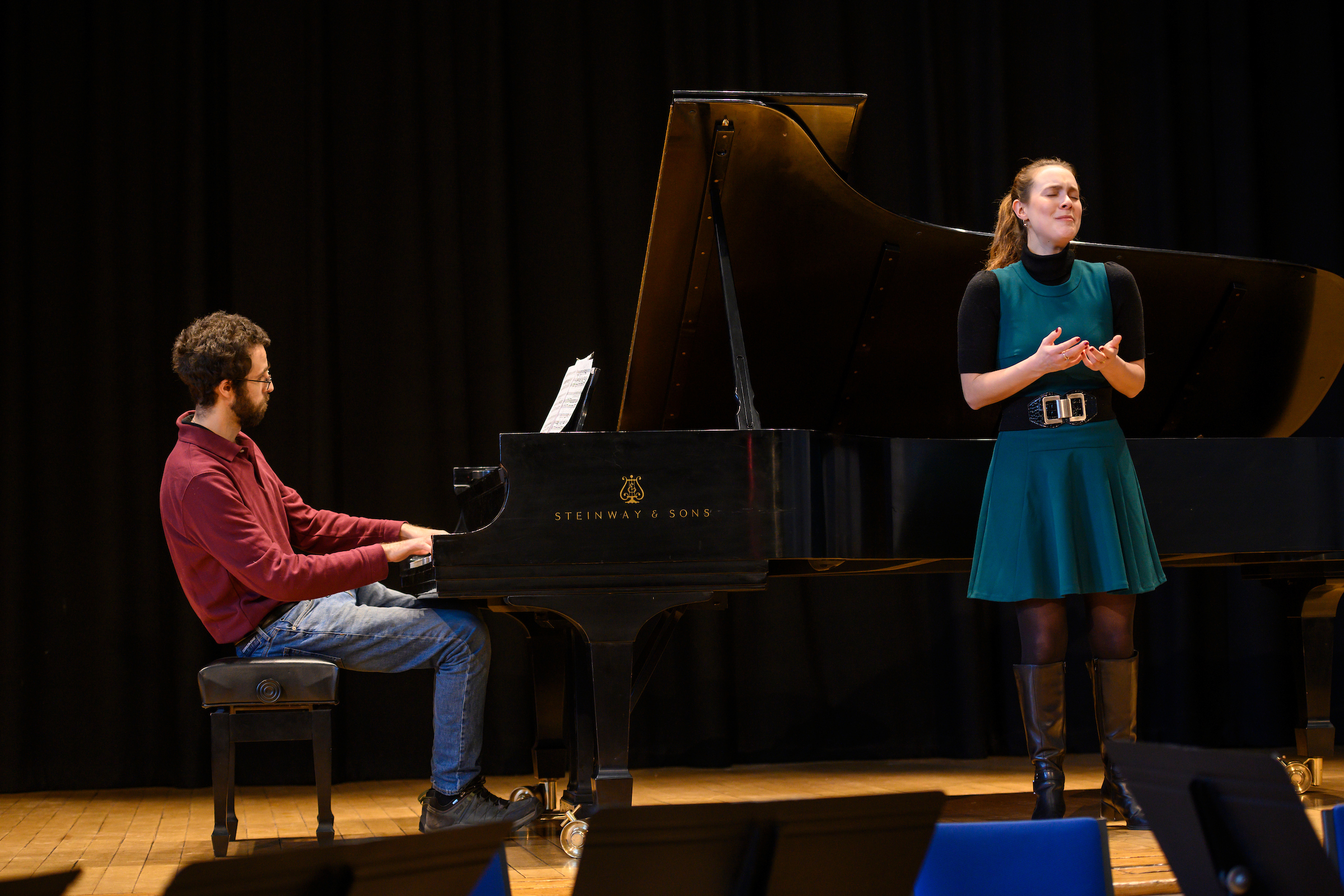 A pianist and singer perform together.