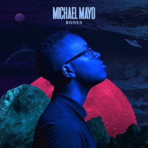 Michael Mayo album cover for Bones. Michael is looking off to the side, lit in bright blue. The background is dark and moody.