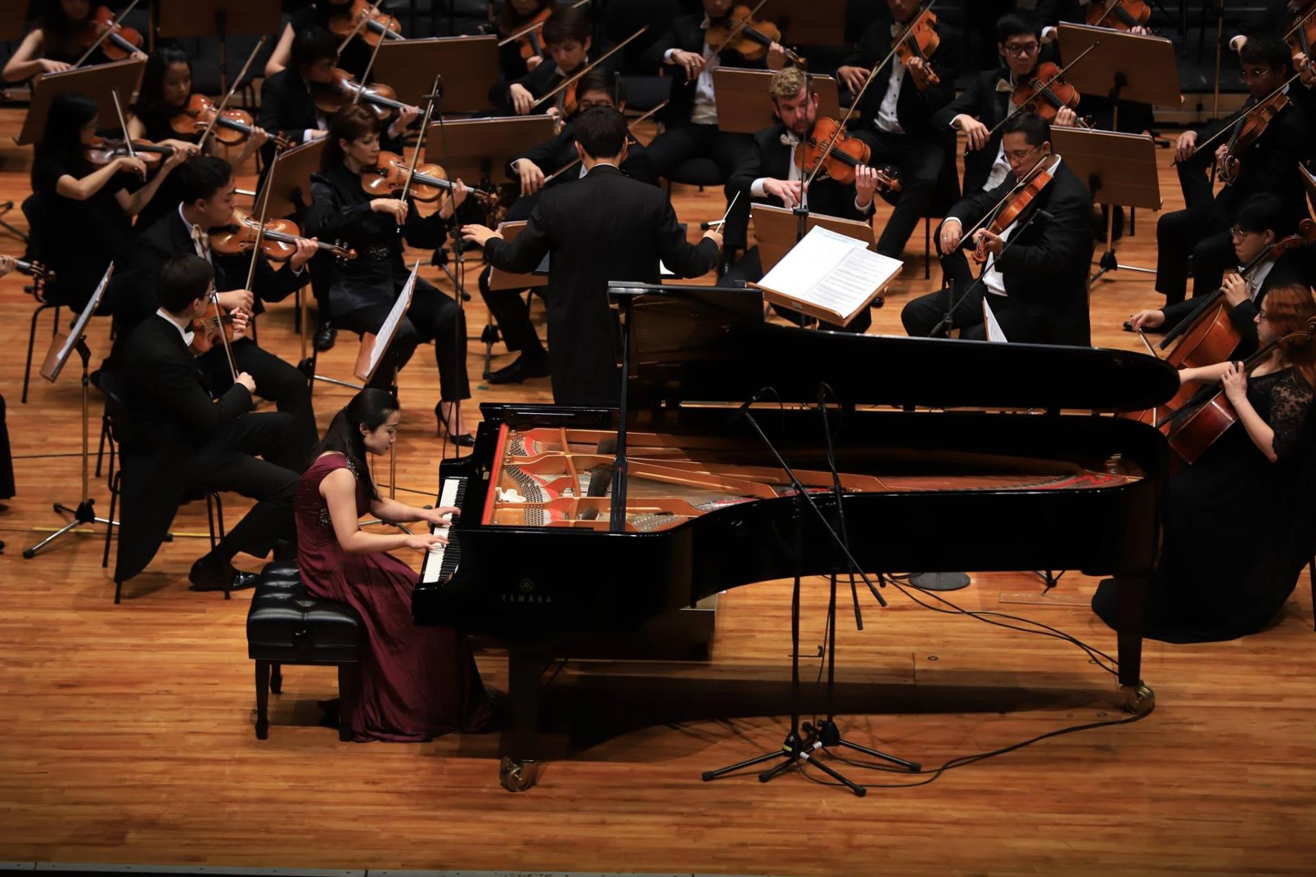 Xu Guo Performing on the Piano on stage at a competition