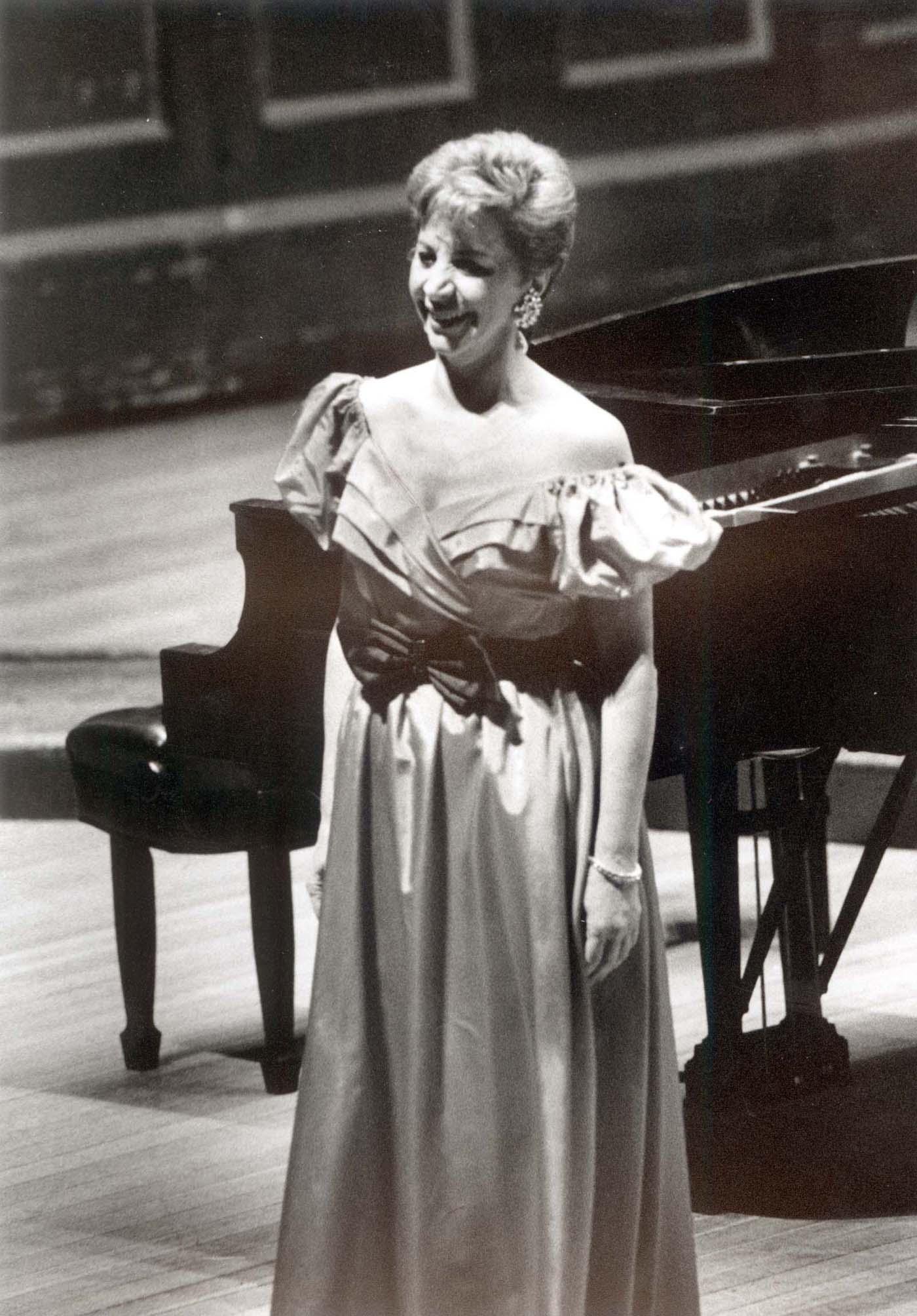 Rosalind Elias smiles while wearing a gown on the Jordan Hall stage.