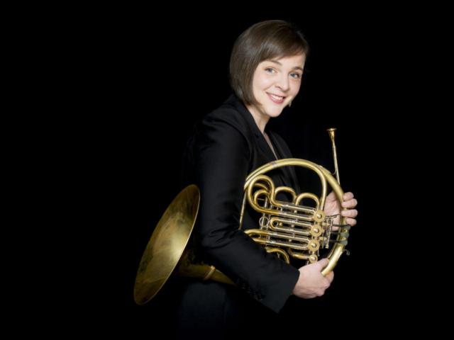 Rachel Childers holding her French horn