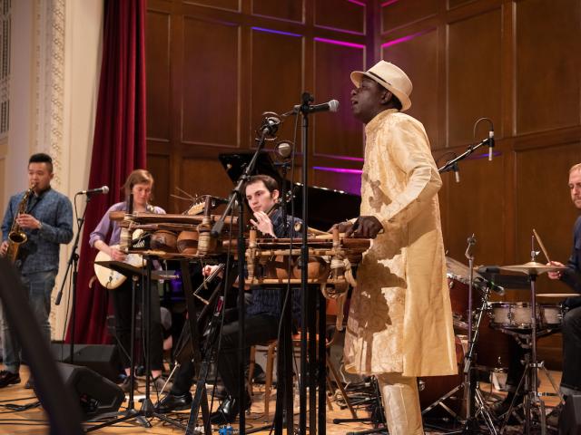 Balla Kouyate plays the balafon and sings while leading students in the West African Ensemble