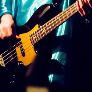 Jazz electric bass player in costume