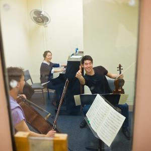 A student gives the thumbs-up from a practice room