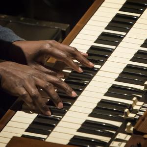Hands on a Hammond B3 keyboard during a Gospel Ensemble concert
