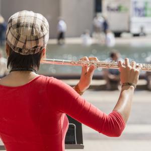 Flutist performs by Reflecting Pool