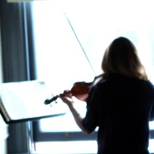 Backlit photo of a violinist practicing.