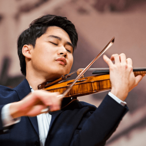 Artist Diploma student Inmo Yang plays the violin with his eyes closed.