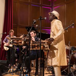 Balla Kouyate plays the balafon and sings while leading students in the West African Ensemble