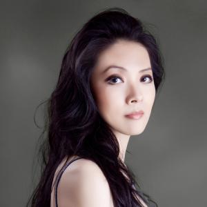 A portrait photo of Ya Fei Chuang. She faces the camera and wears a blue gown.