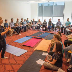 Alexander Technique lesson at open studios - students sitting around yoga mats