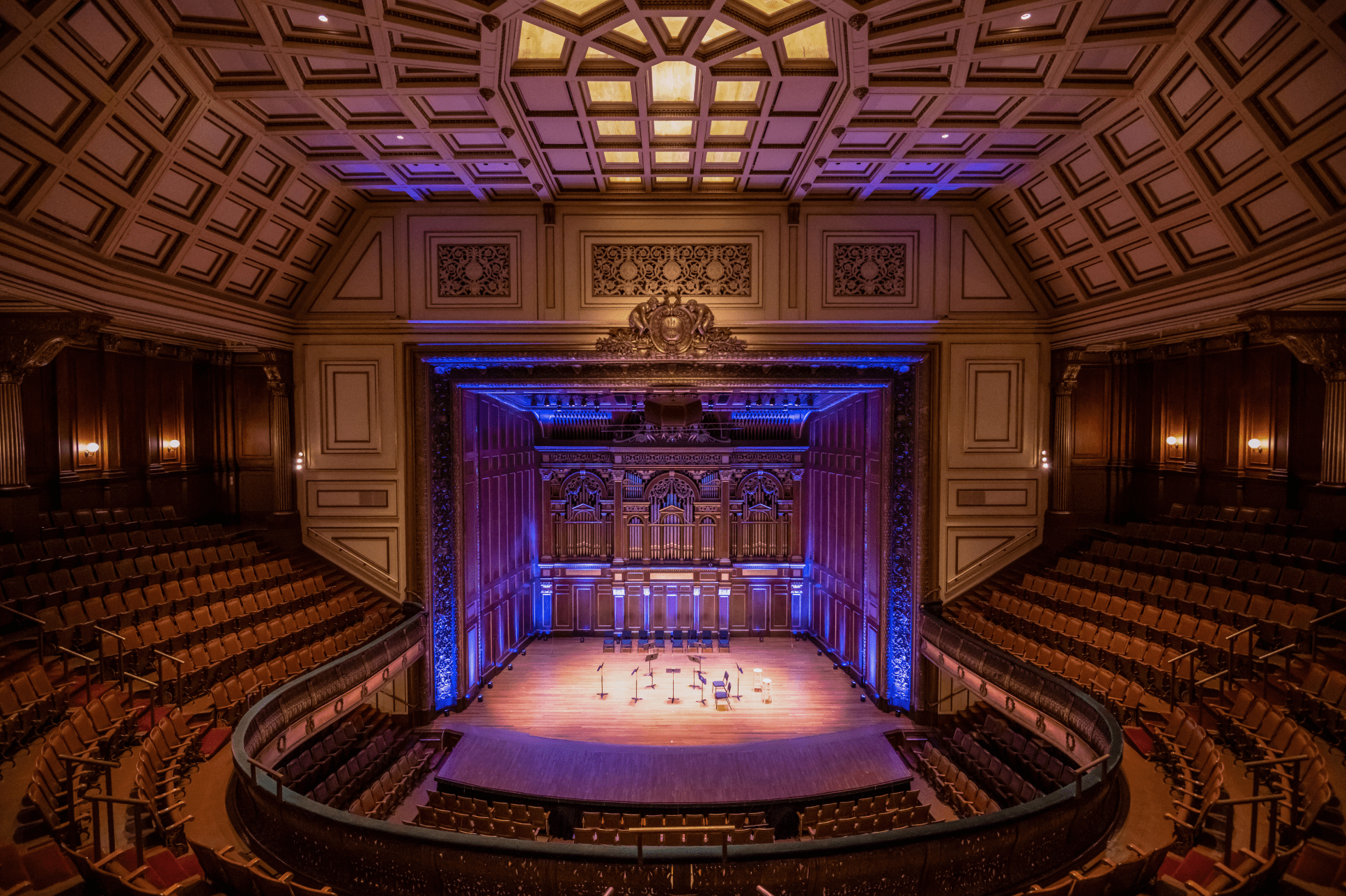 Jordan hall empty with blue stage lighting.