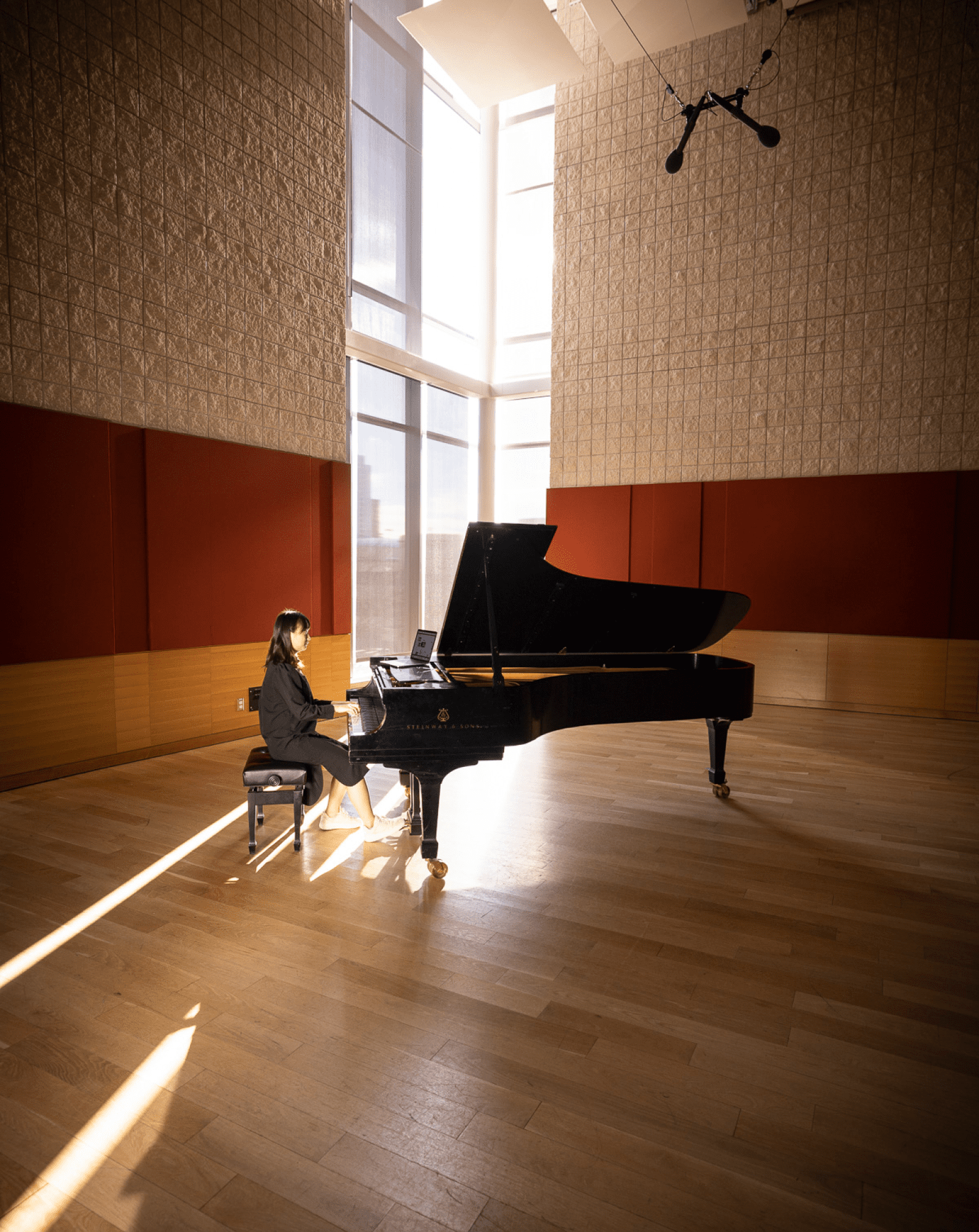 Student An-Ni Wei poses at piano in Burnes Hall