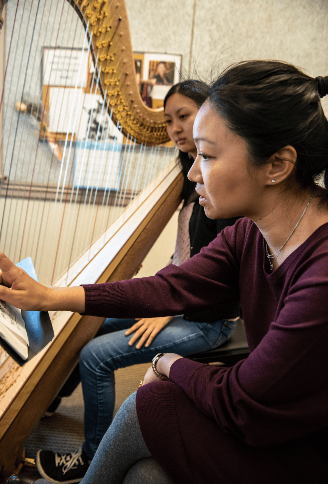 Jessica Zhou instructing harp student
