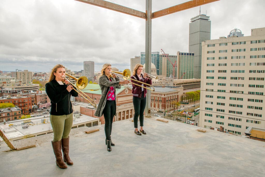 Shots of a brass trio on the roof of the work-in-progress SLPC