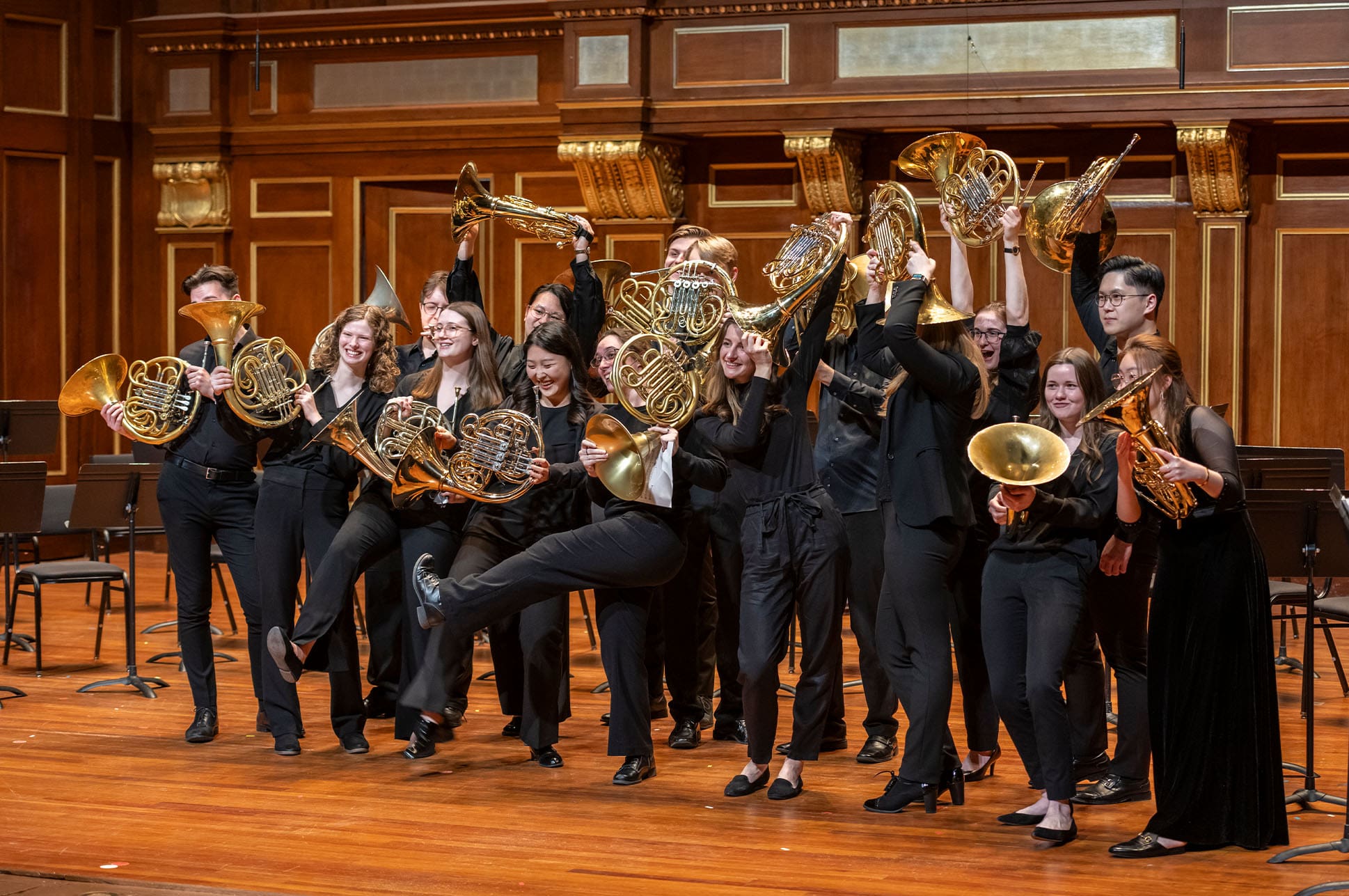 Students with brass instruments on the Jordan Hall stage.