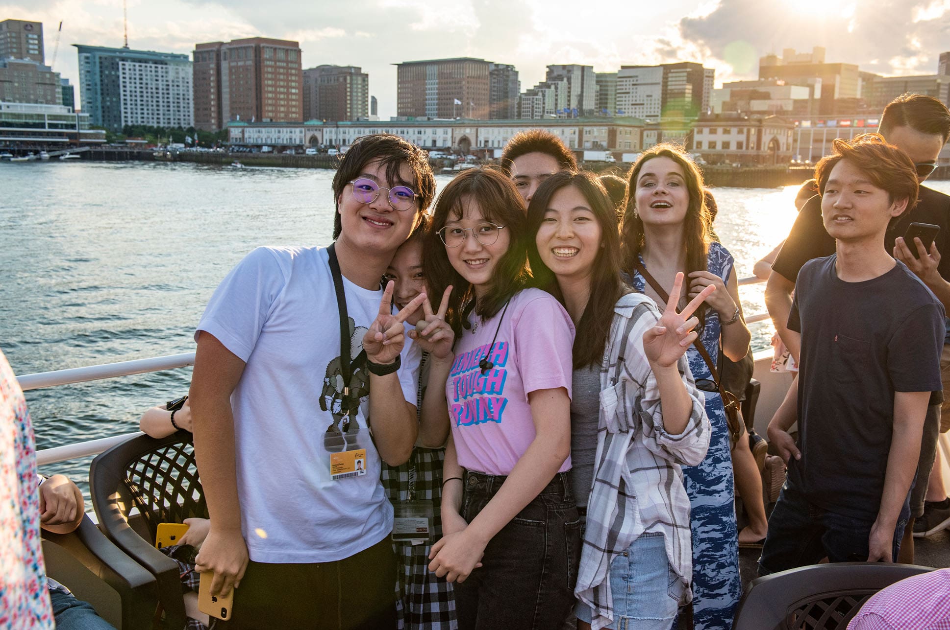 NEC students smiling while taking a Boston harbor cruise.