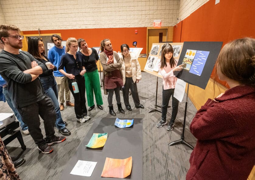 A student presenting an art project in a visual arts class.