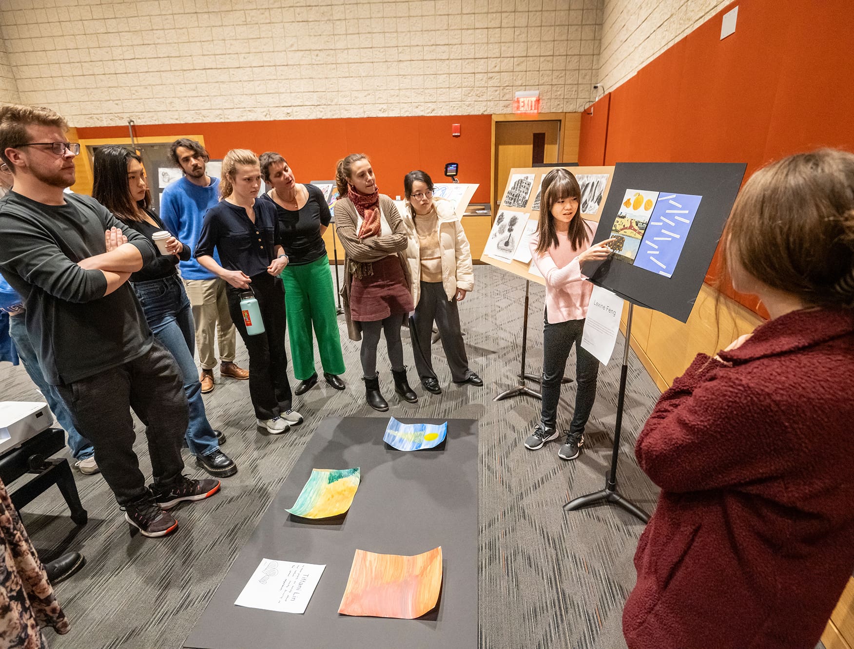 A student presenting an art project in a visual arts class.