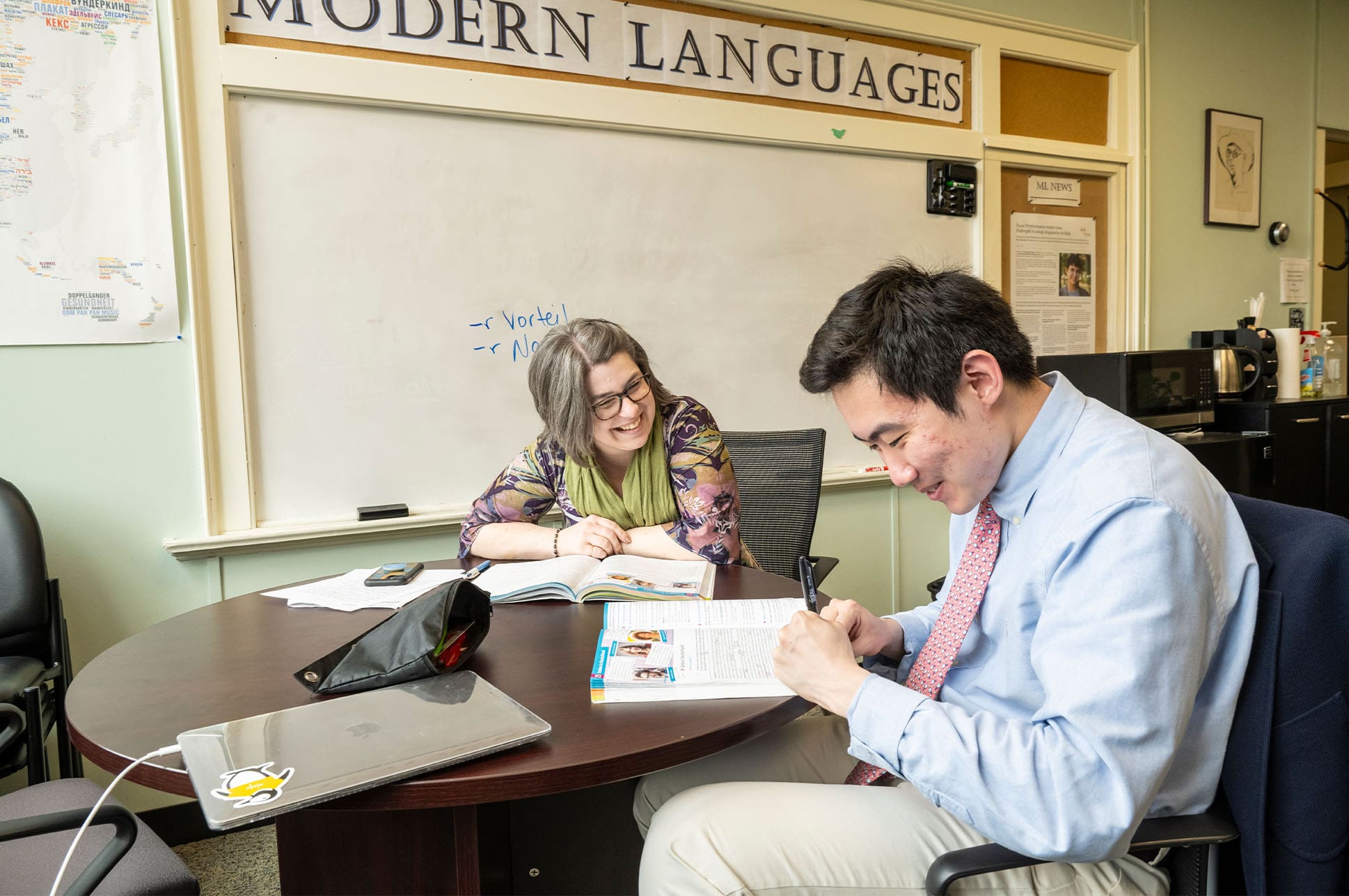 Modern languages student and teacher at a table.