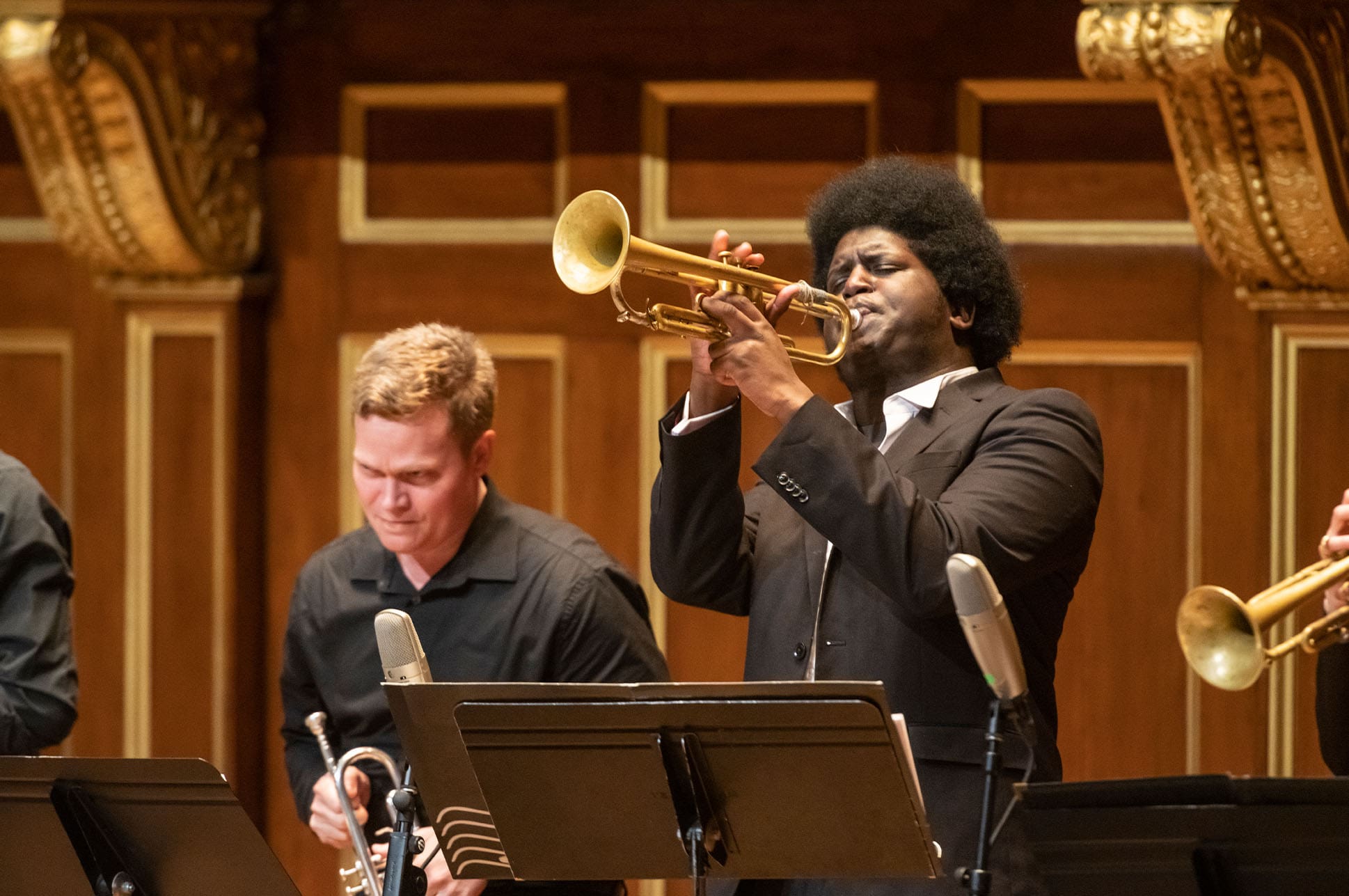 A student playing trumpet on the Jordan Hall stage.