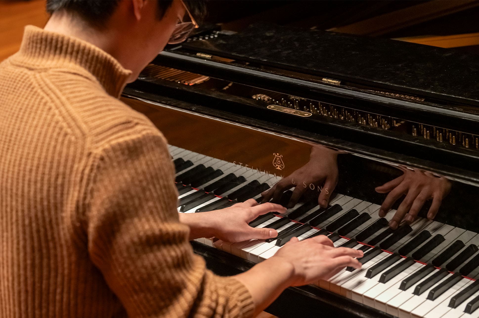 Student playing piano.