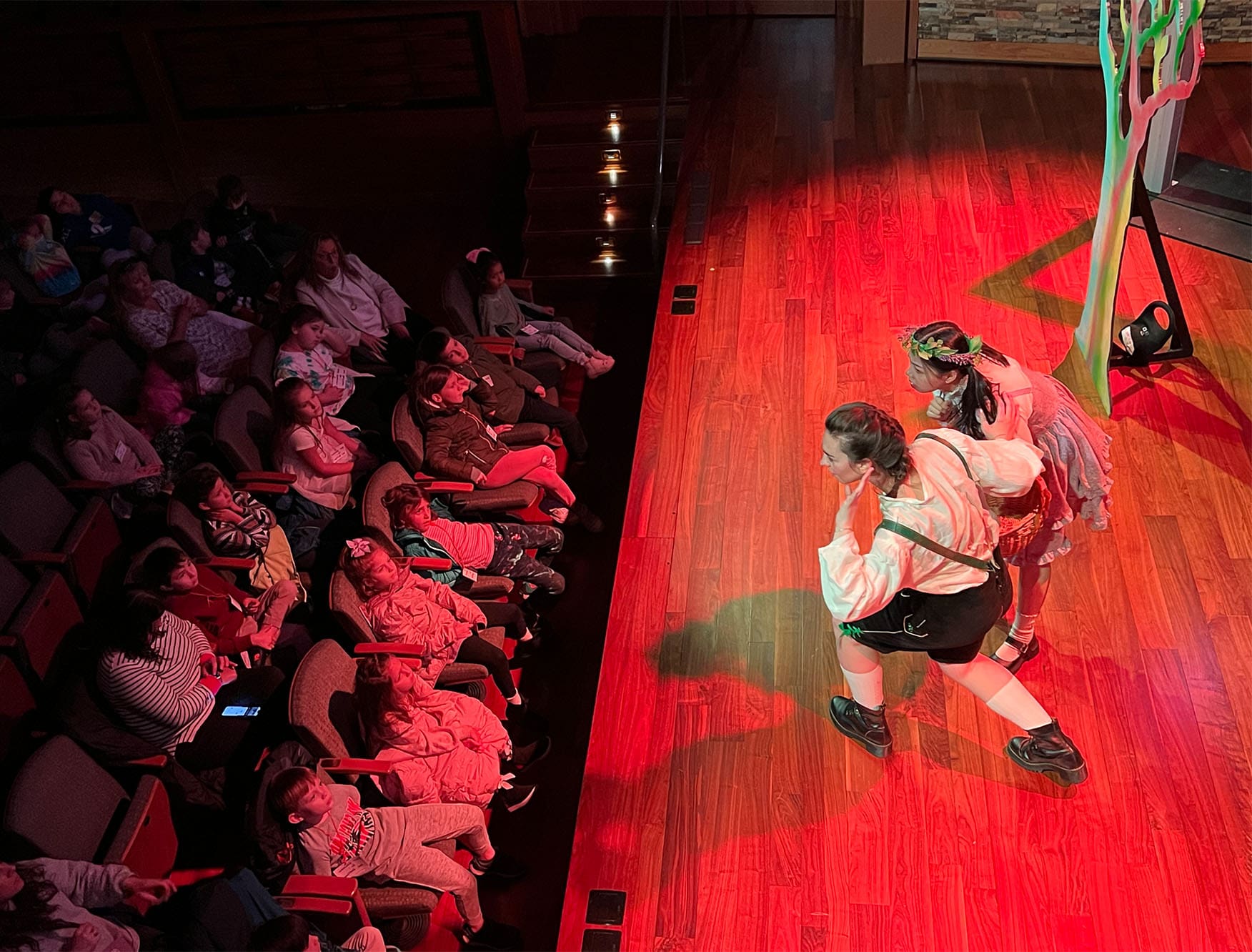 Two children performing in an opera on a stage.