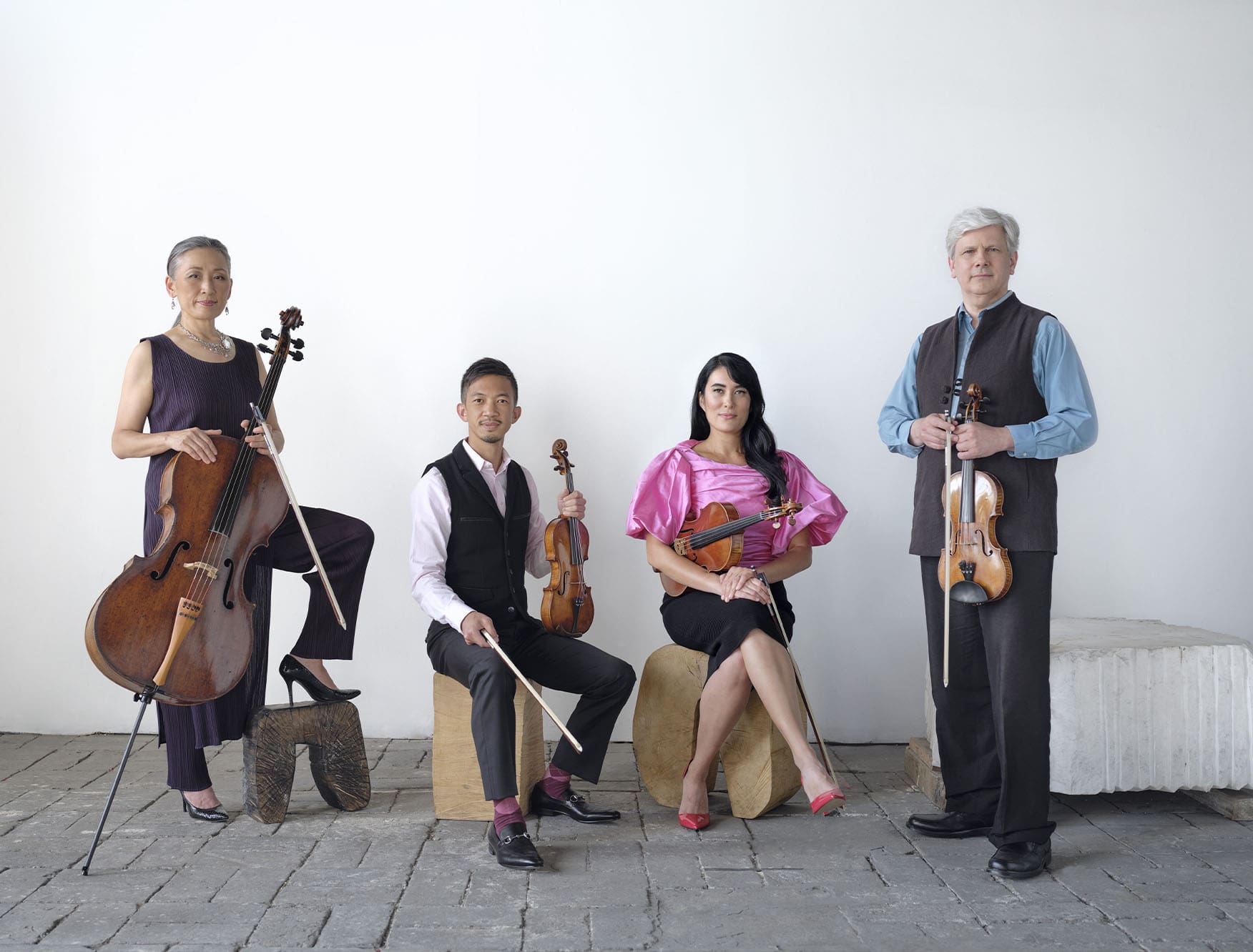 A string quartet posing for a portrait.