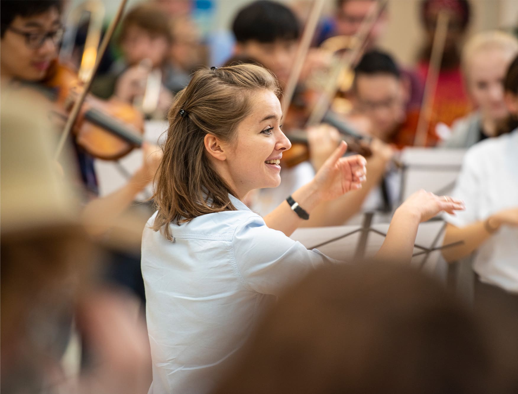 A conductor leading a group of musicians.