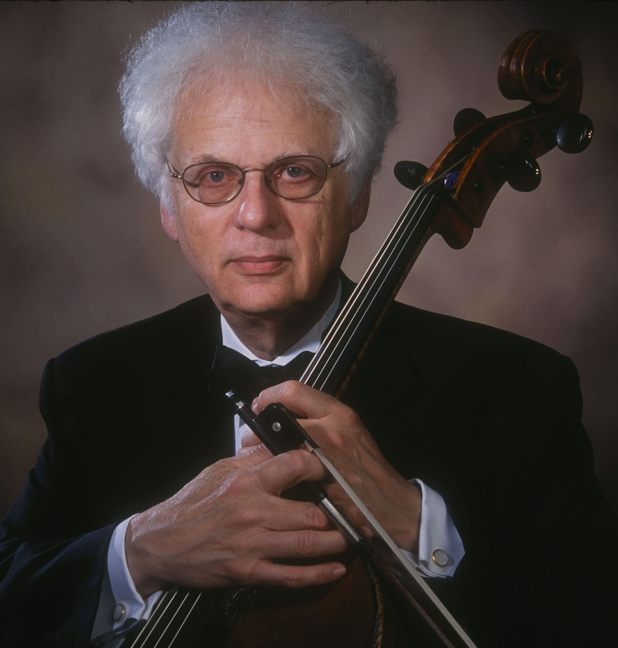 Portrait image of NEC President Laurence Lesser holding cello