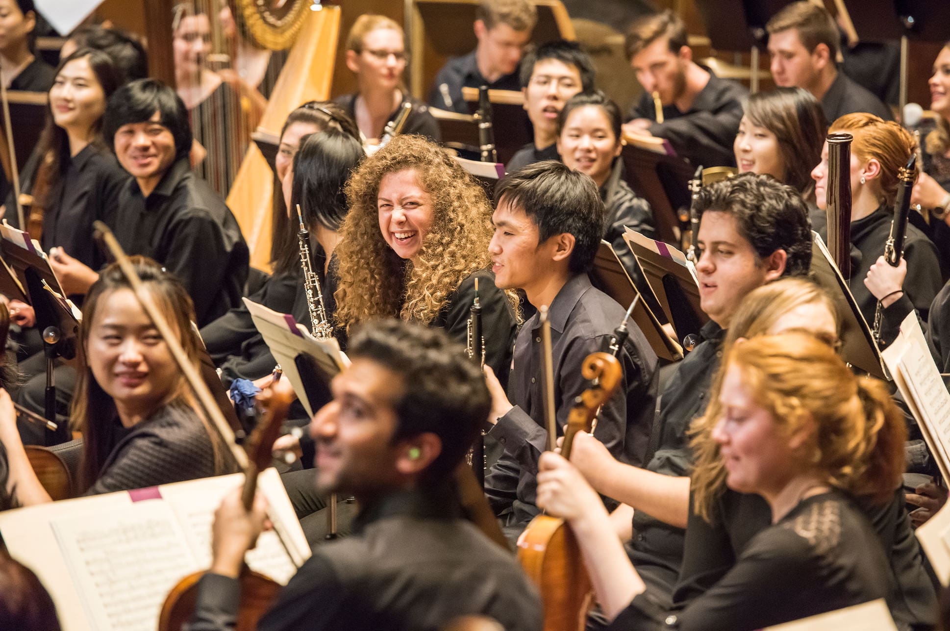 Students sitting together in an orchestra.