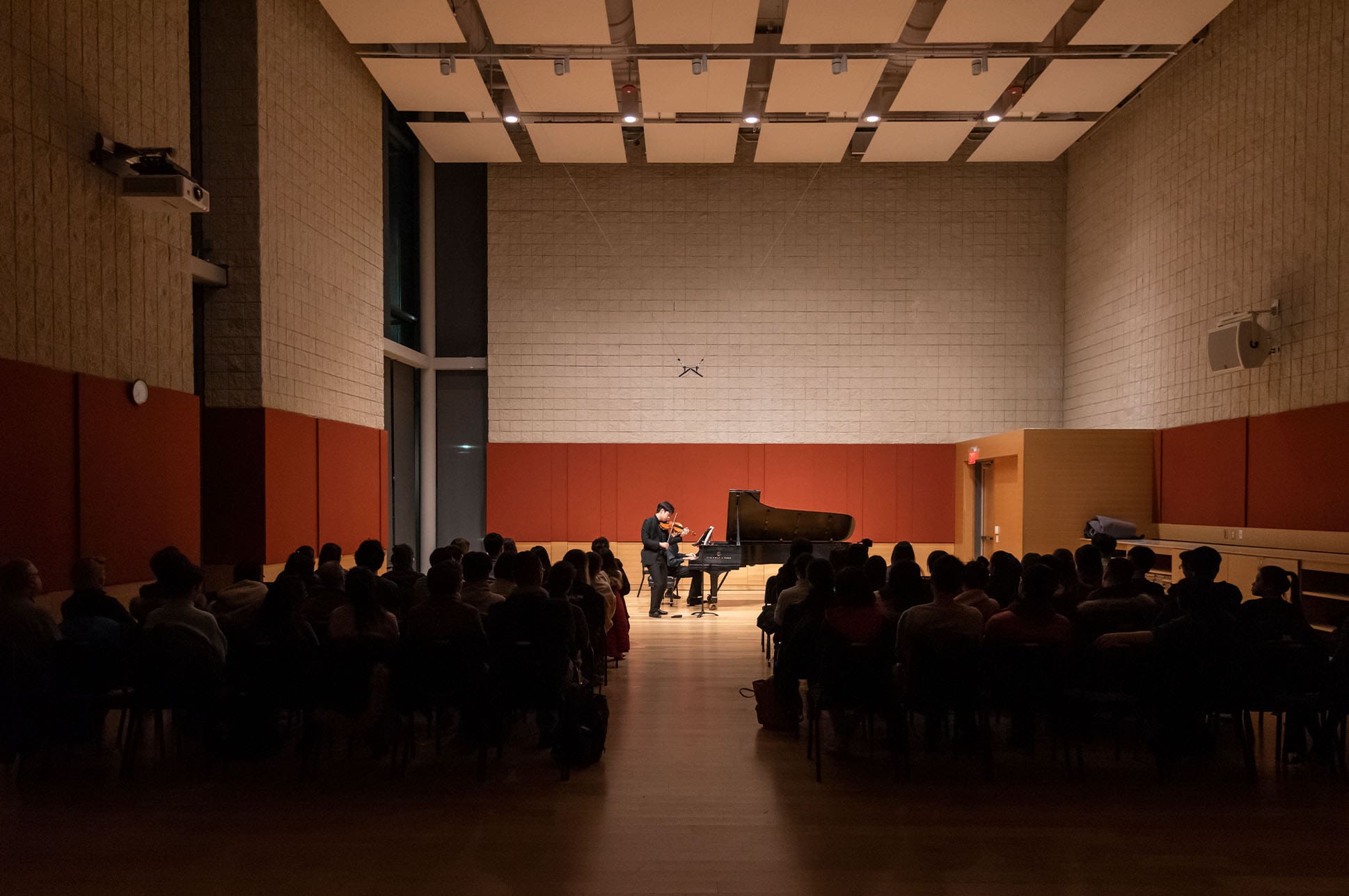 Person performing on a piano in Burnes Hall.