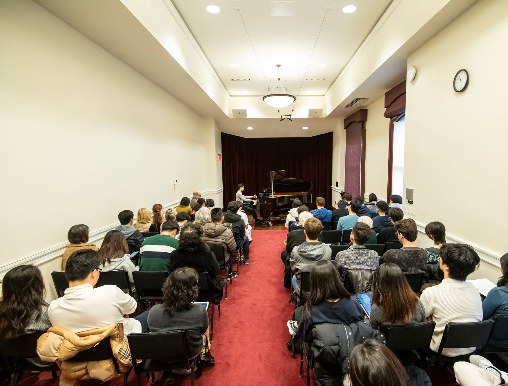 Student playing piano in the Keller Room.