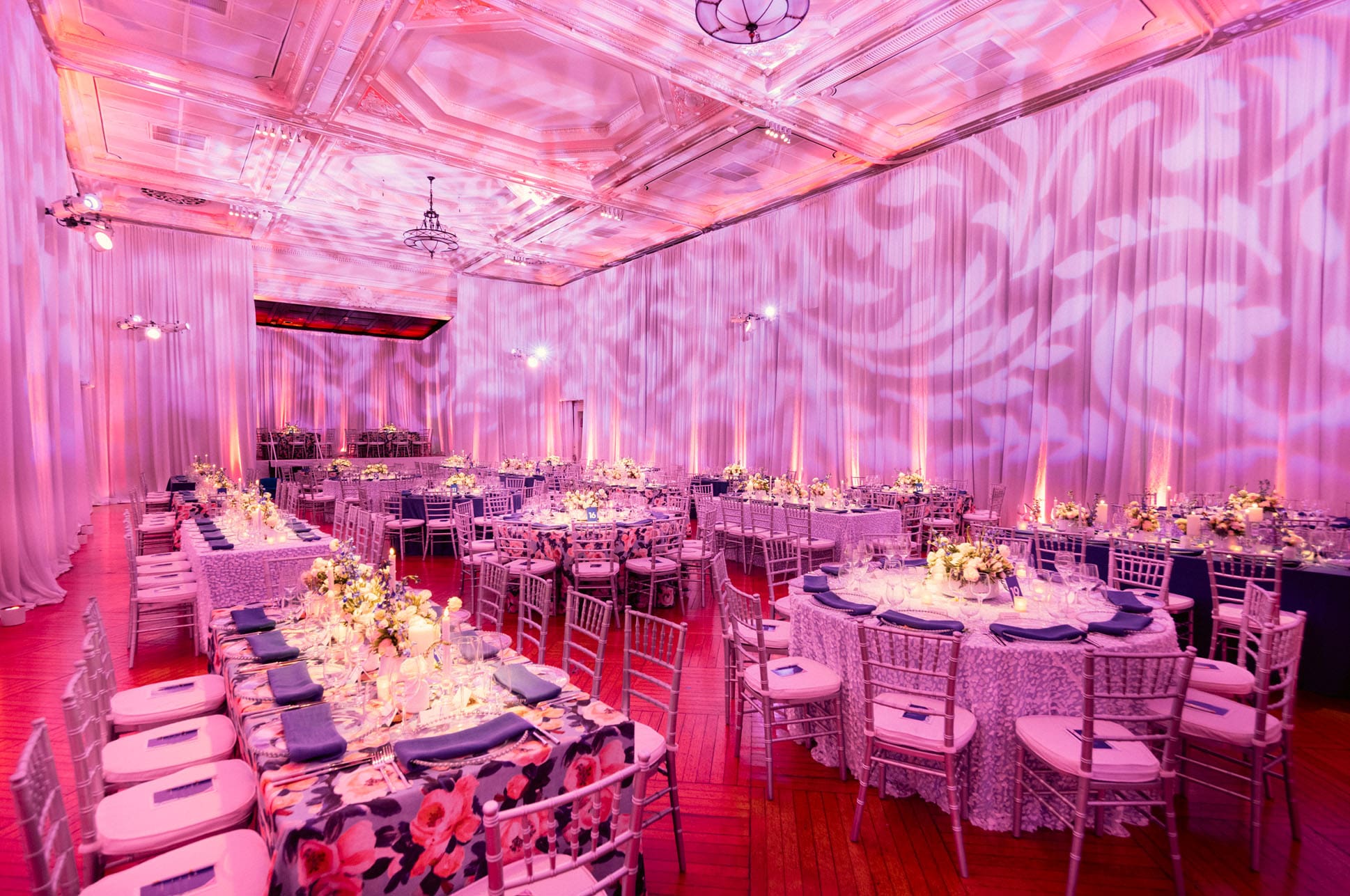 Tables and chairs set up in a festively lit room.
