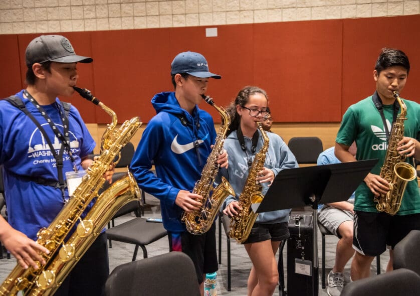 Young students playing in a woodwinds ensemble.