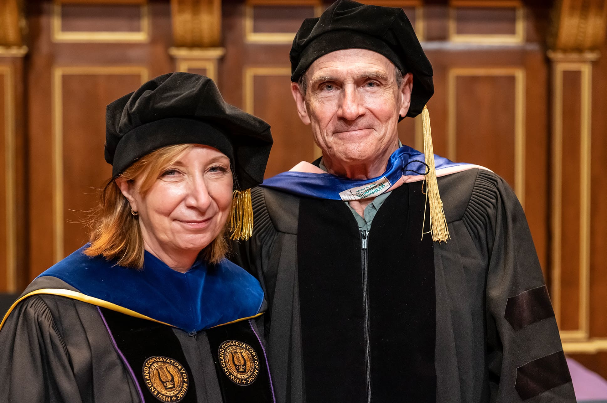 NEC President Andrea Kalyn with Honorary Doctorate recipient James Taylor.